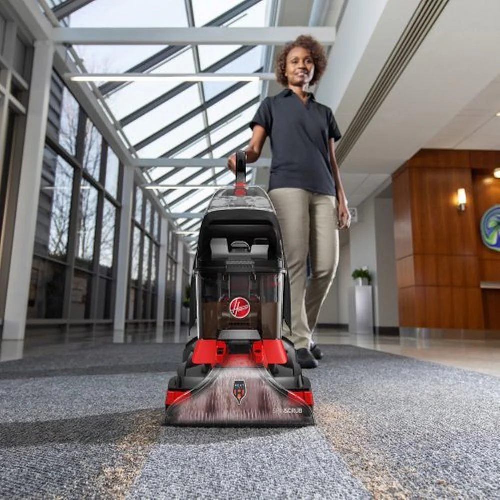 Technician performing professional carpet cleaning, revitalizing a large office space in Tampa Bay